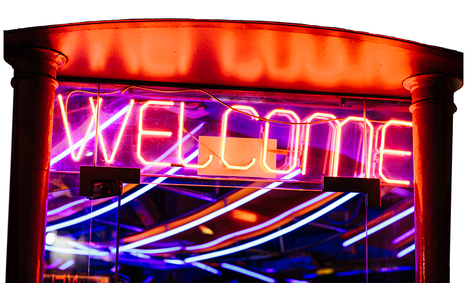 a neon sign reading WELCOME