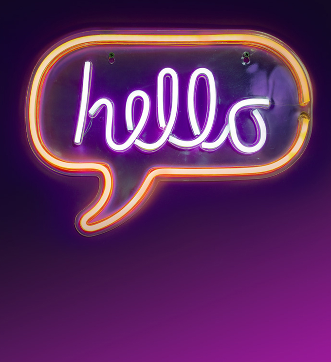 a neon sign the word Hello in a comment bubble